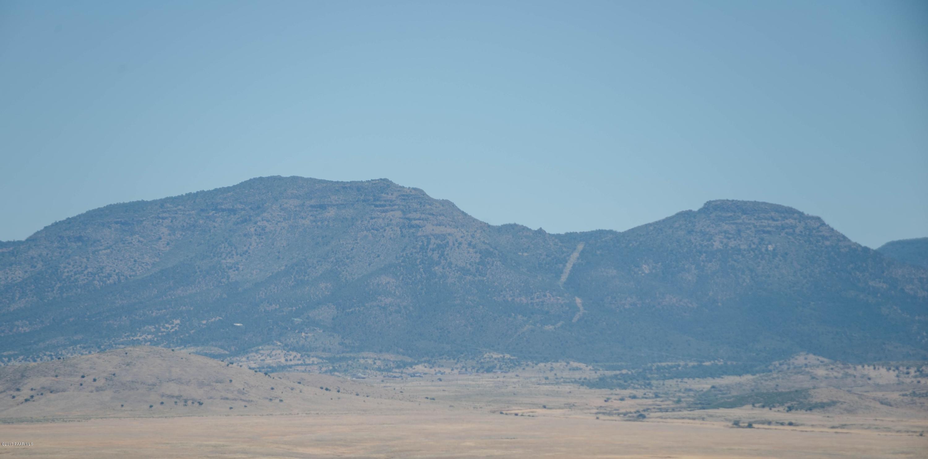 3265 North Yavapai Road East Prescott Valley, AZ 86314 - Photo 3 of 19 a view of a dry yard with mountain in the background