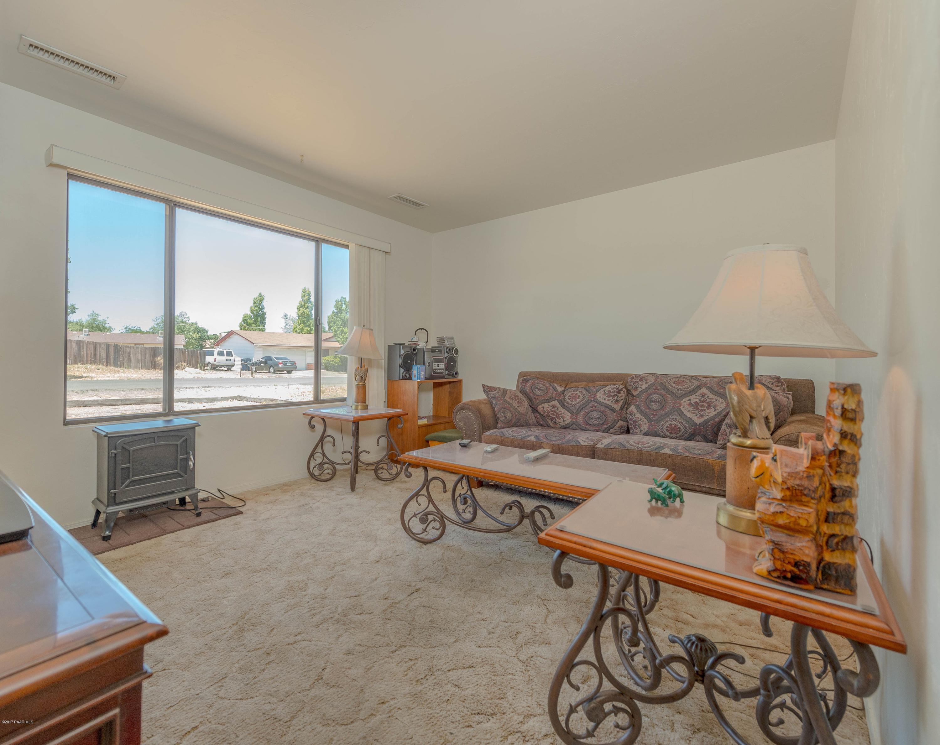3265 North Yavapai Road East Prescott Valley, AZ 86314 - Photo 5 of 19 a living room with furniture a window and a table