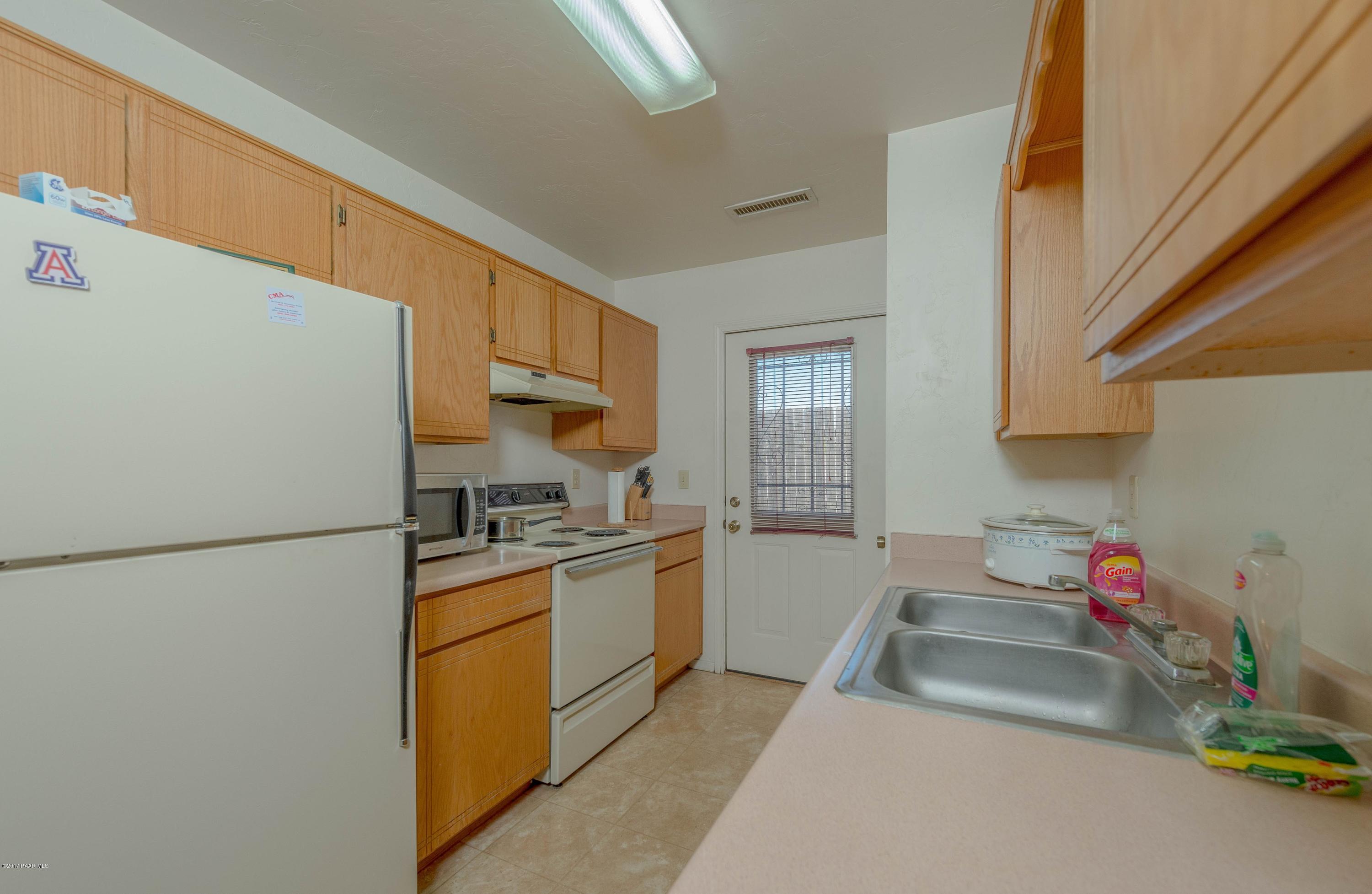 3265 North Yavapai Road East Prescott Valley, AZ 86314 - Photo 6 of 19 a kitchen with a sink a stove and refrigerator