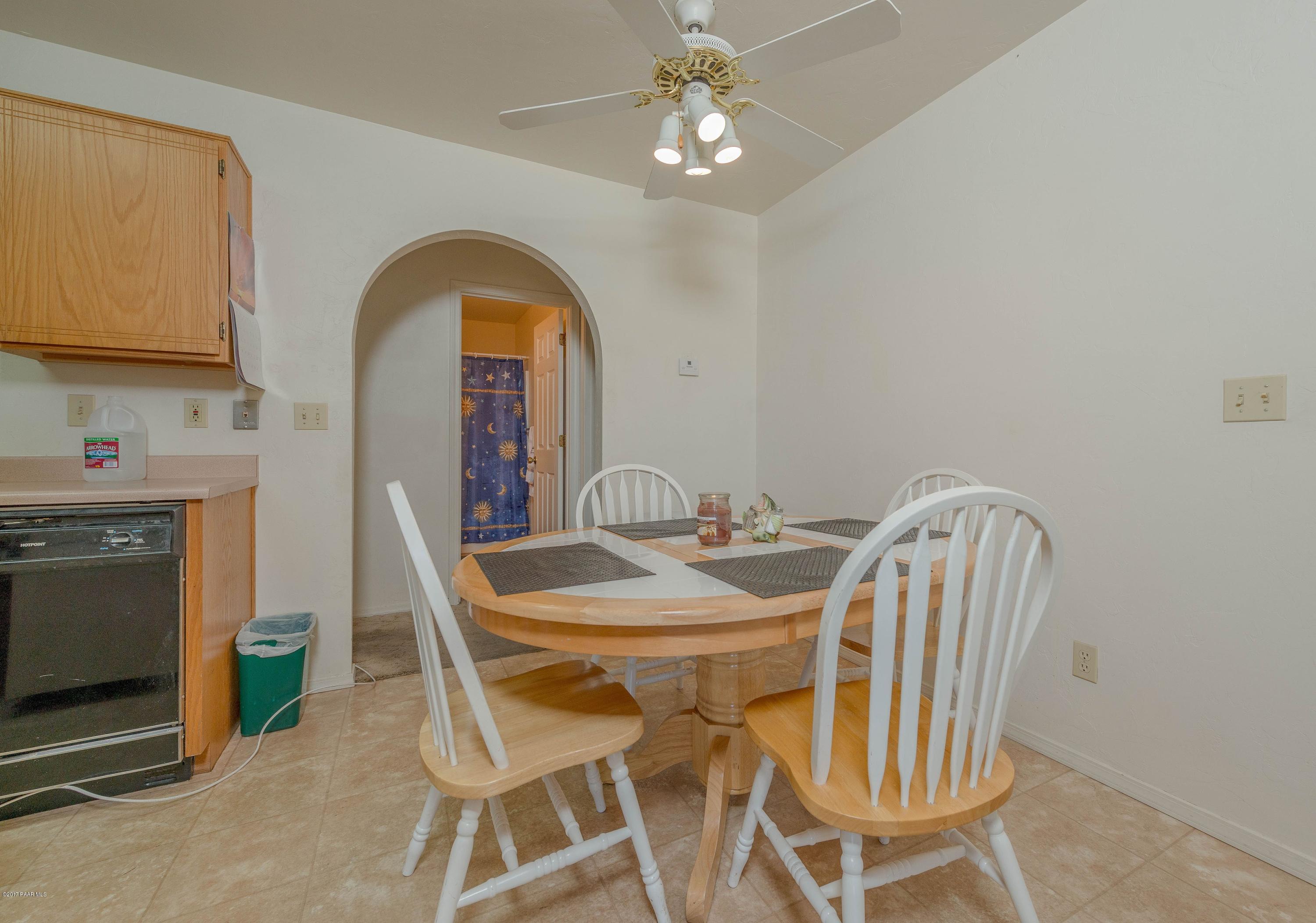 3265 North Yavapai Road East Prescott Valley, AZ 86314 - Photo 8 of 19 a view of a dining room with furniture and chandelier
