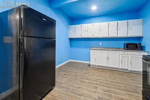 a kitchen with stainless steel appliances a refrigerator and cabinets