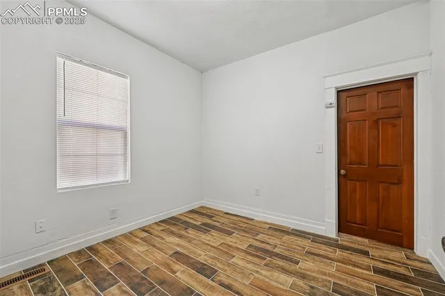 an empty room with windows and closet