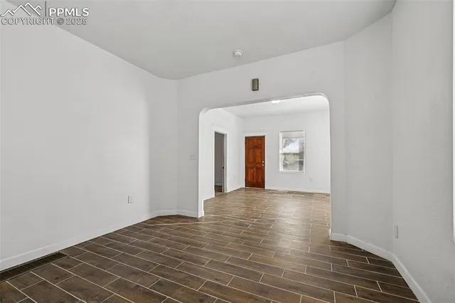 a view of a room with wooden floor