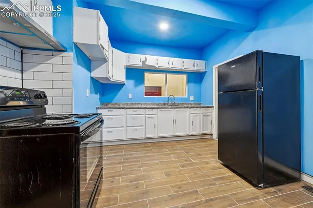 a kitchen with stainless steel appliances granite countertop a stove a refrigerator and a sink
