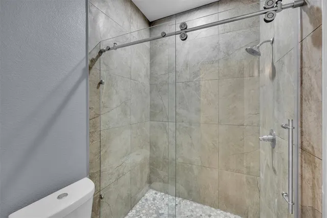 a bathroom with a shower and toilet