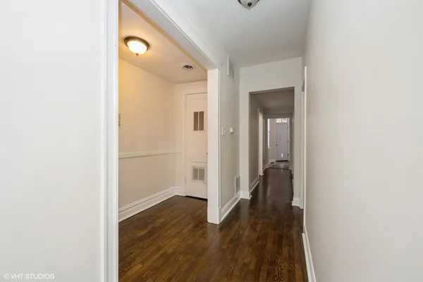 a view of a hallway with wooden floor