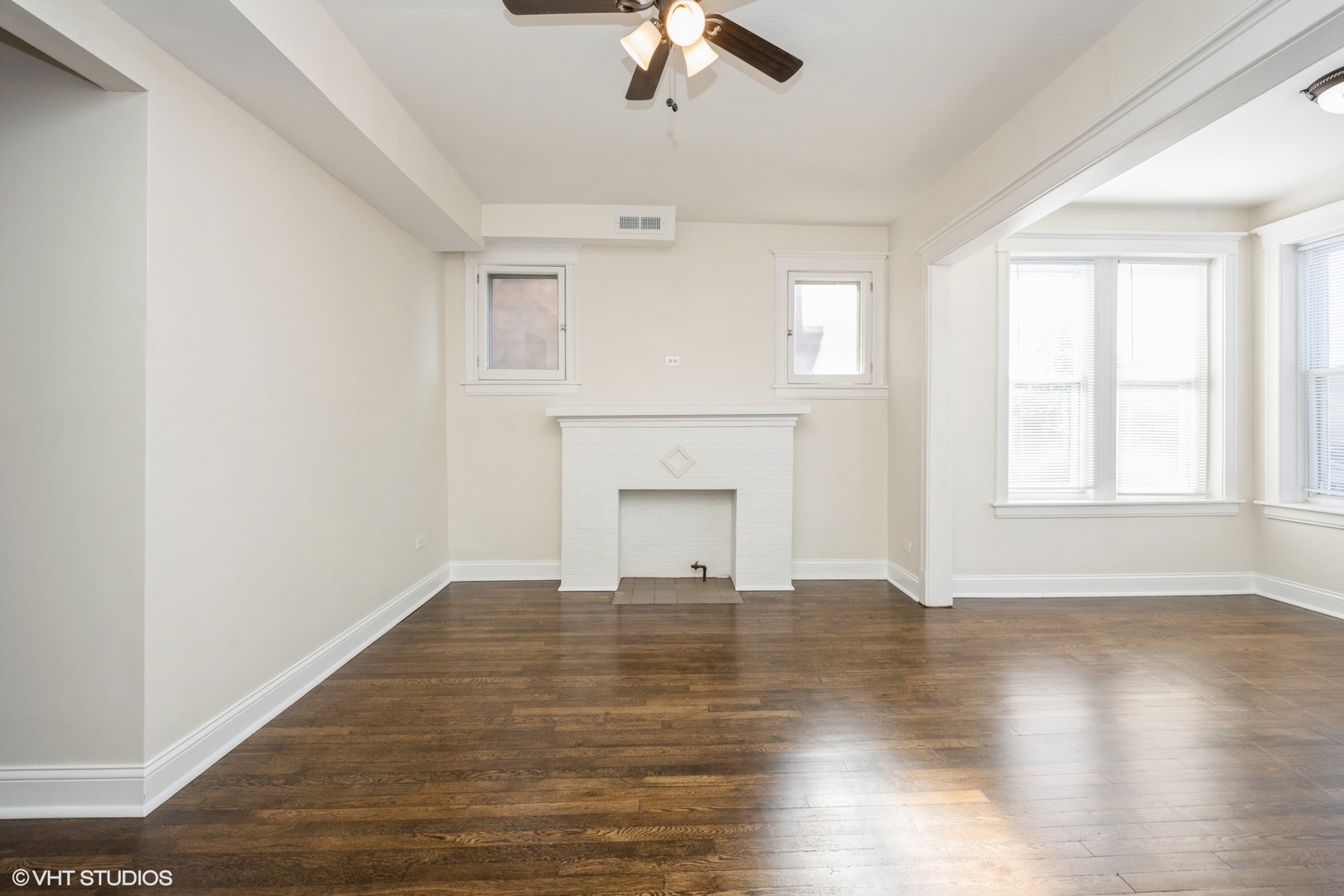 4954 West Augusta Boulevard, Unit 1 Chicago, IL 60651 - Photo 13 of 15 a view of empty room with wooden floor and fan