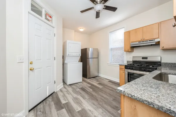 a kitchen with stainless steel appliances granite countertop a stove a refrigerator and a sink