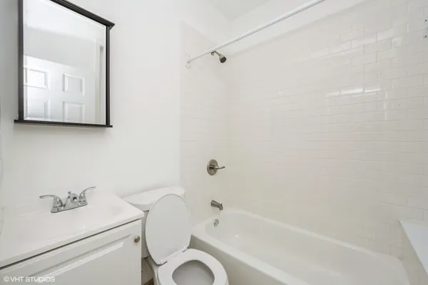 a bathroom with a sink a toilet and bathtub