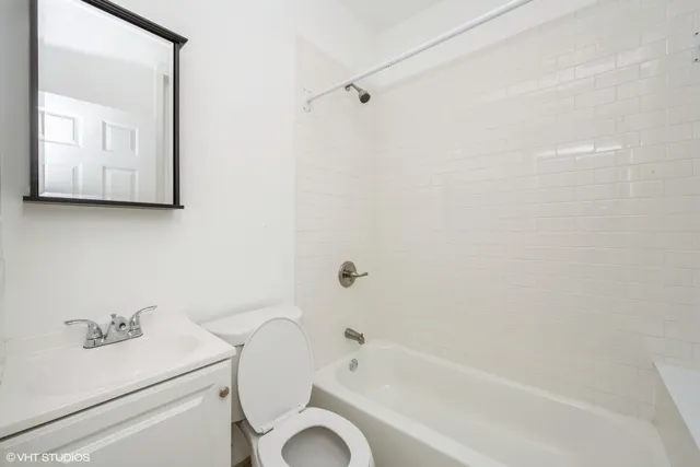 a bathroom with a sink a toilet and bathtub