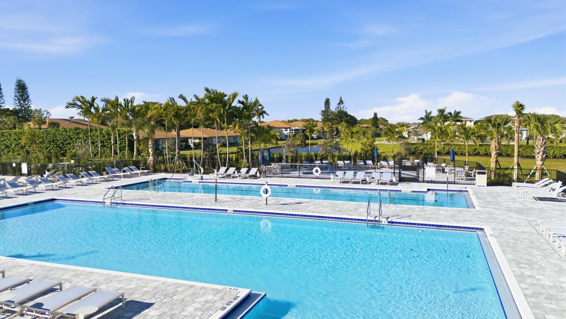 13670 Vía Flora, Unit B Delray Beach, FL 33484 - Photo 24 of 36 a view of swimming pool with outdoor seating and trees in the background