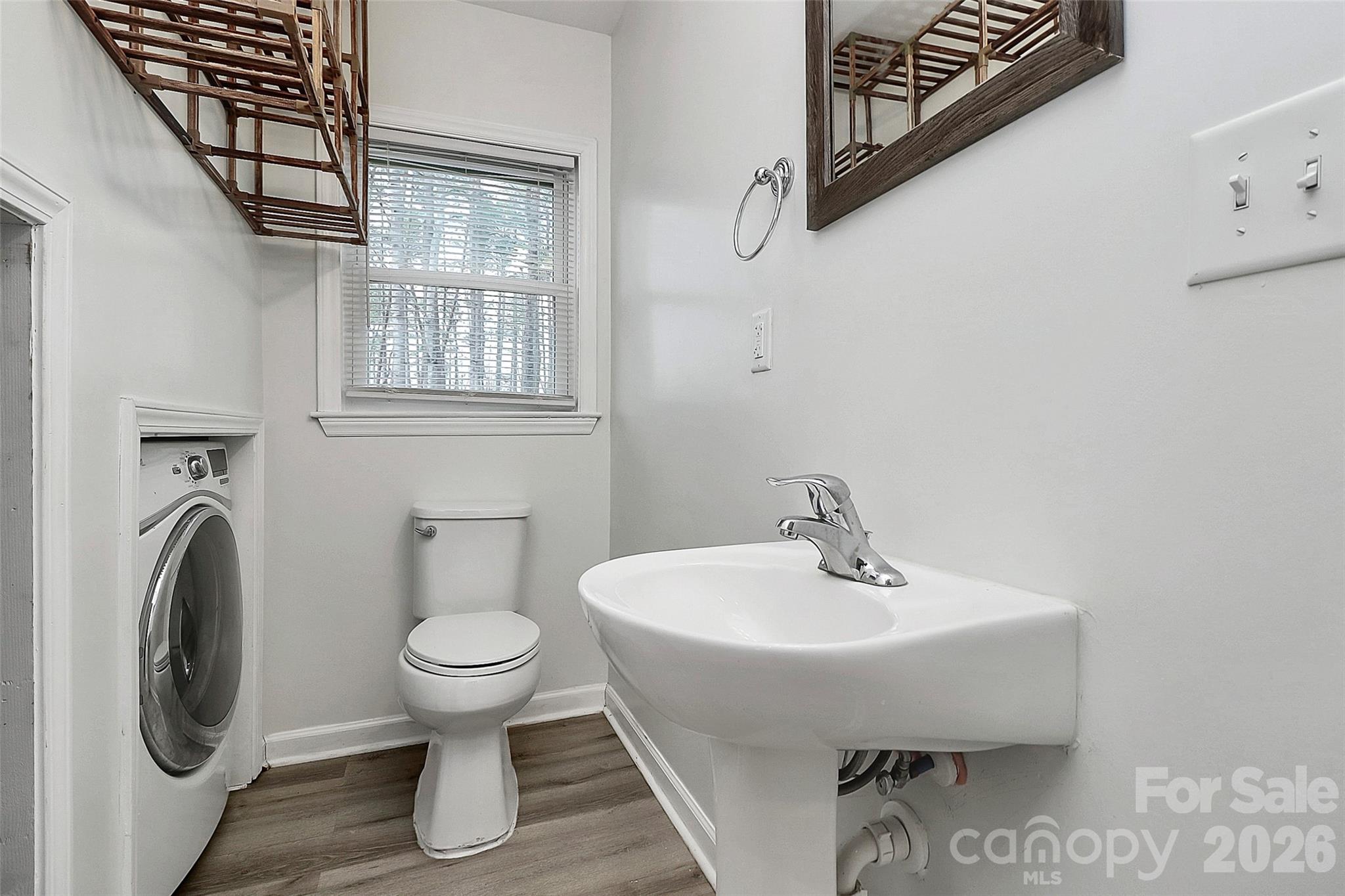 8591 Bartlett Road Mint Hill, NC 28227 - Photo 16 of 45 a bathroom with a sink a toilet and a mirror