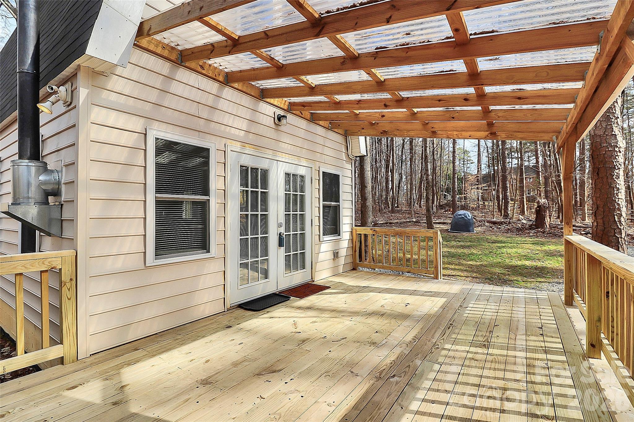 8591 Bartlett Road Mint Hill, NC 28227 - Photo 2 of 45 a view of a patio with a table and chairs and wooden fence