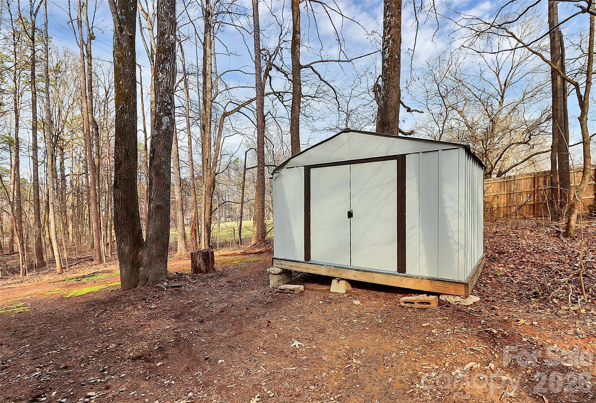 8591 Bartlett Road Mint Hill, NC 28227 - Photo 33 of 45 a view of a house with backyard and tree