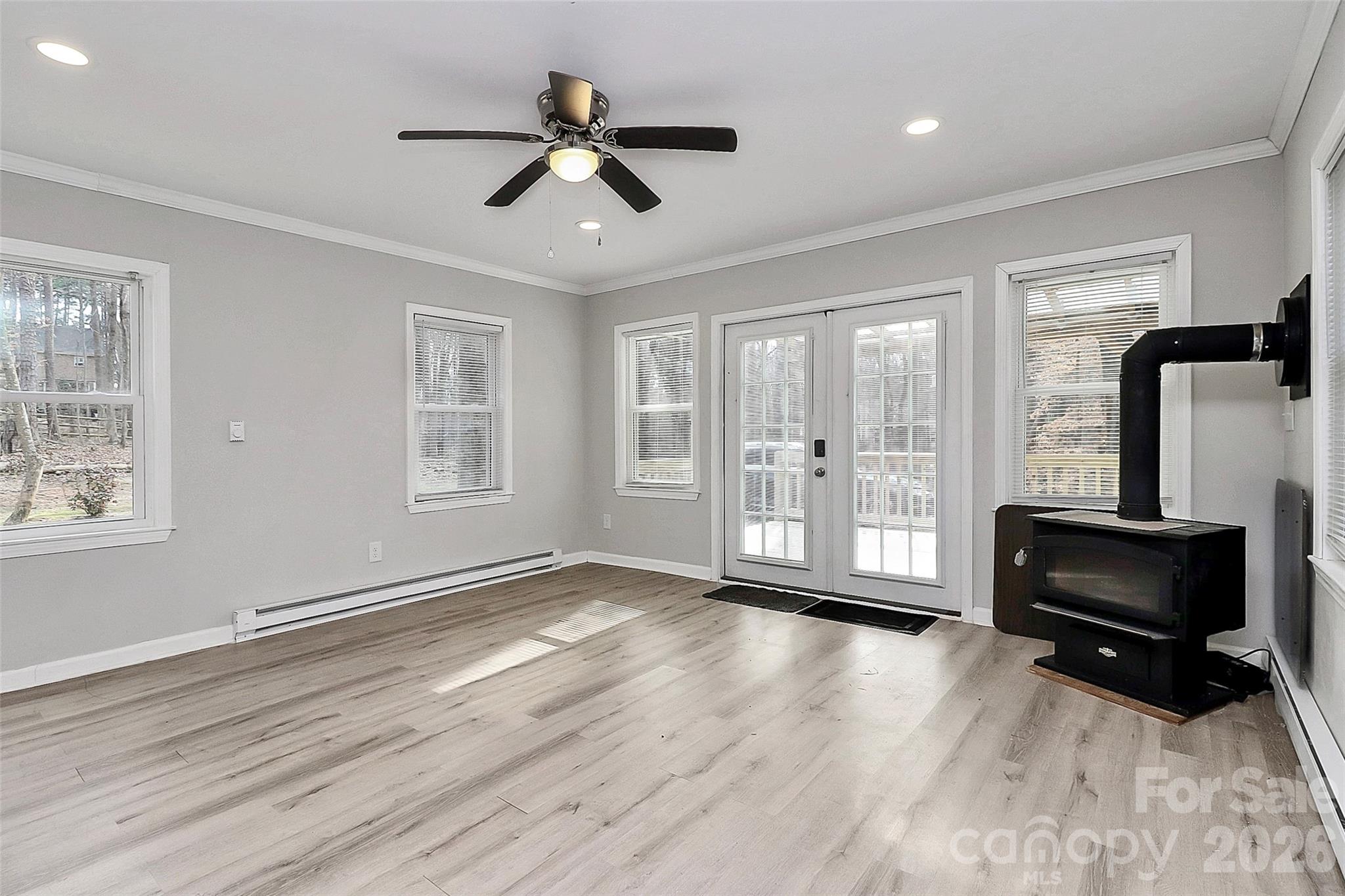 8591 Bartlett Road Mint Hill, NC 28227 - Photo 8 of 45 a view of livingroom with hardwood floor ceiling fan and windows