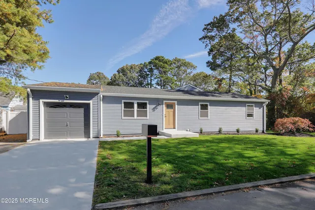 a front view of house with yard and green space