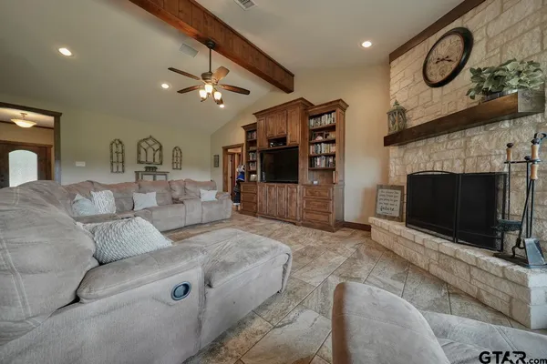a living room with furniture a flat screen tv and a fireplace
