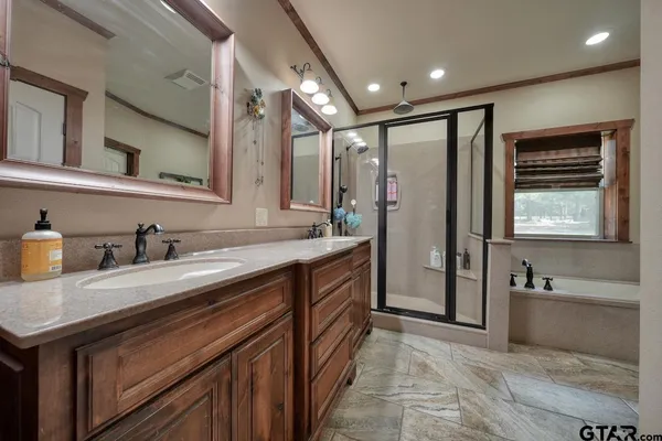 a spacious bathroom with a granite countertop sink mirror and bathtub