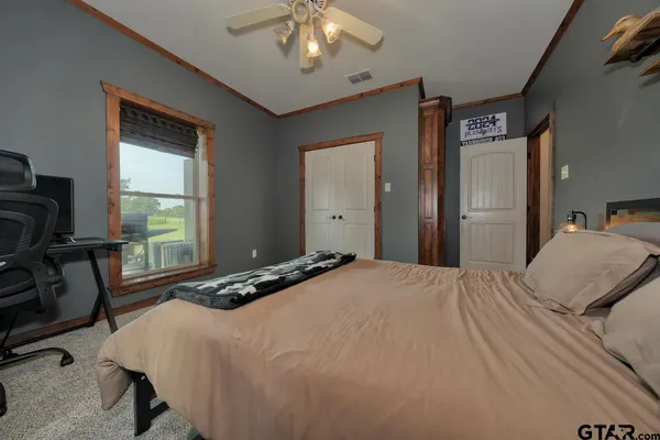 a bedroom with a bed and a chandelier