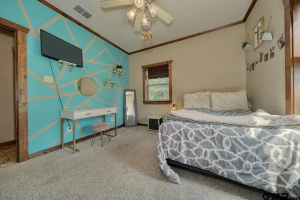 a bedroom with a bed and a chandelier