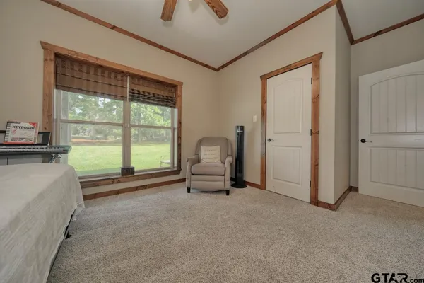 a room with a bed and a large window