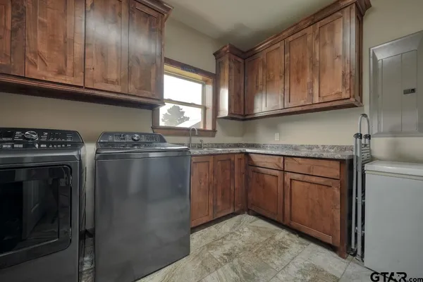 a kitchen with granite countertop cabinets stainless steel appliances and a window