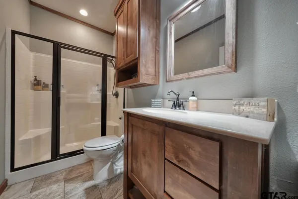 a bathroom with a sink toilet and shower