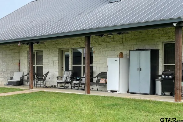 a backyard of a house with table and chairs