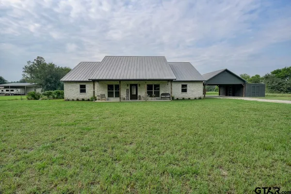 a front view of house with yard and green space