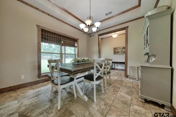 a dining room with furniture and window
