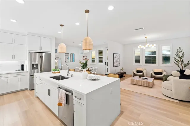 a kitchen with stainless steel appliances a refrigerator sink and cabinets