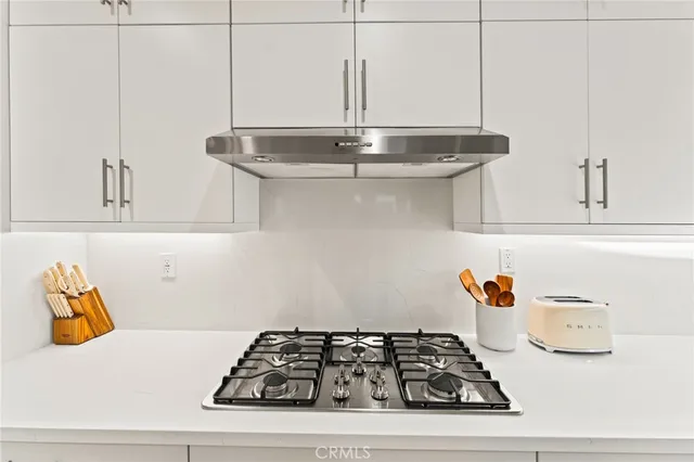 a kitchen with stainless steel appliances kitchen island granite countertop a refrigerator and a stove top oven