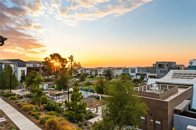 a living room with furniture a flat screen tv and a floor to ceiling window