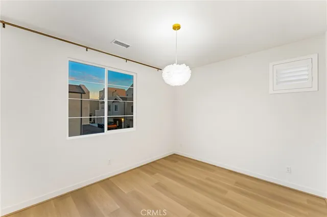 a view of a balcony with floor to ceiling windows with wooden floor