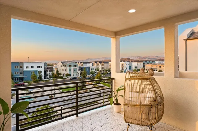 a roof deck with couches and potted plants
