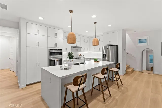 a kitchen with stainless steel appliances granite countertop a stove and a sink