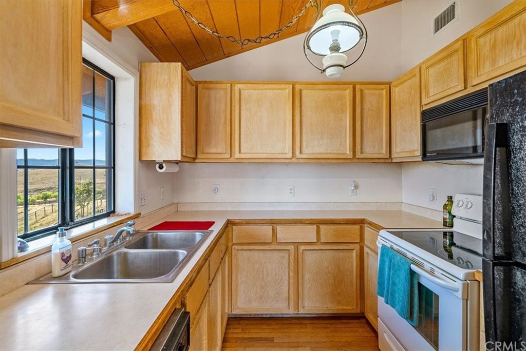 8700 Bee Tree Road Paso Robles, CA 93446 - Photo 27 of 74 a kitchen with stainless steel appliances granite countertop a sink and a stove