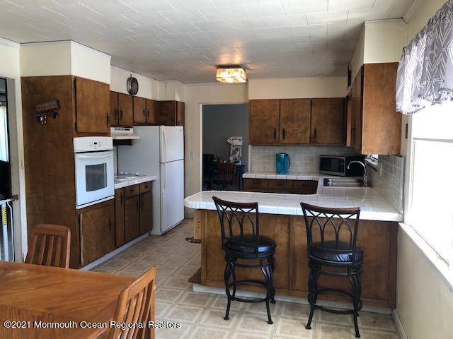 8 Inman Road New Egypt, NJ 08533 - Photo 6 of 18 a kitchen with stainless steel appliances a refrigerator a stove a sink a dining table and chairs