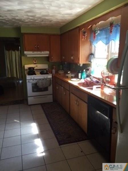 128 Magnolia Road Iselin, NJ 08830 - Photo 5 of 9 a kitchen with stainless steel appliances a sink stove and cabinets