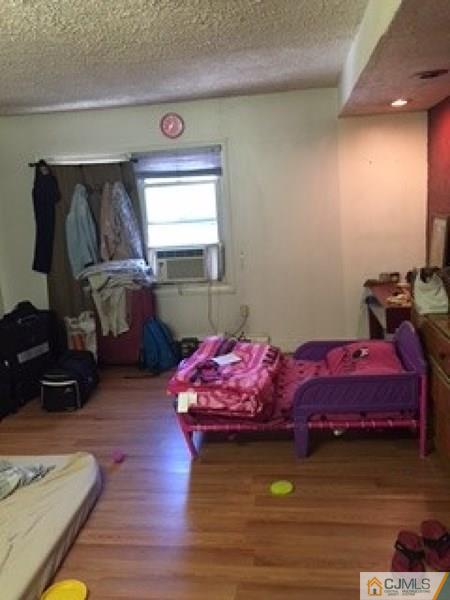 128 Magnolia Road Iselin, NJ 08830 - Photo 7 of 9 a bedroom with furniture and a wooden floor
