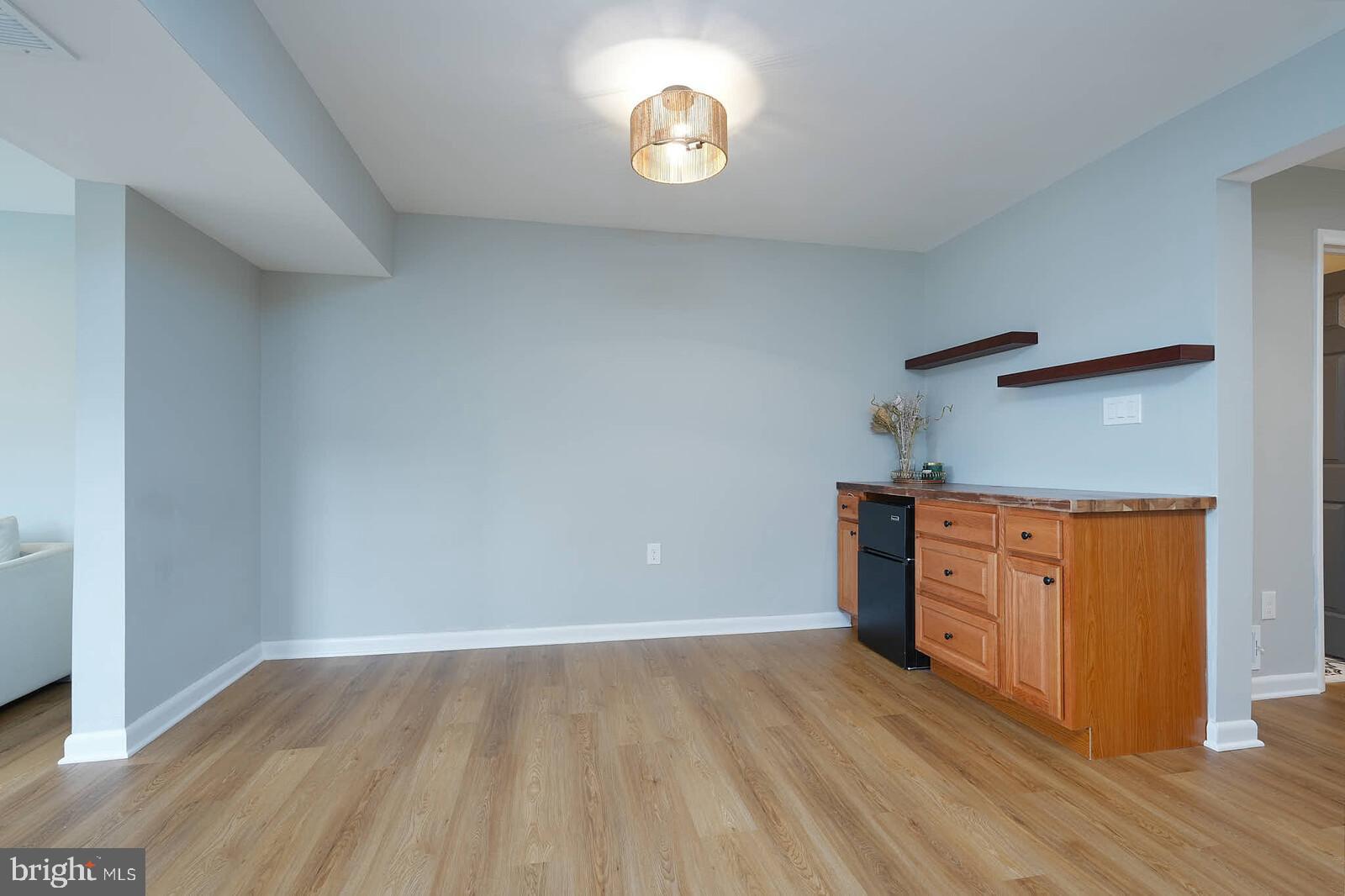 2425 Skyland Place Southeast Washington, DC 20020 - Photo 12 of 41 a kitchen with a wooden floor and cabinets