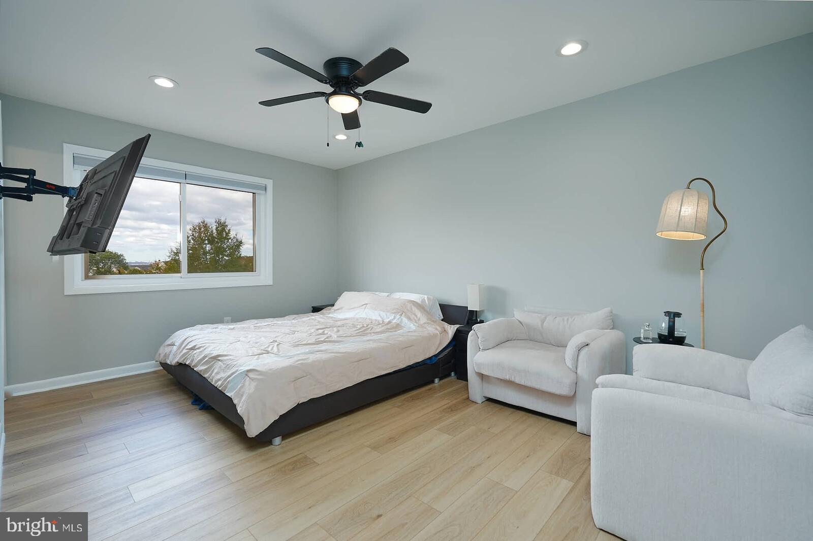 2425 Skyland Place Southeast Washington, DC 20020 - Photo 21 of 41 a bedroom with a bed chandelier and a window