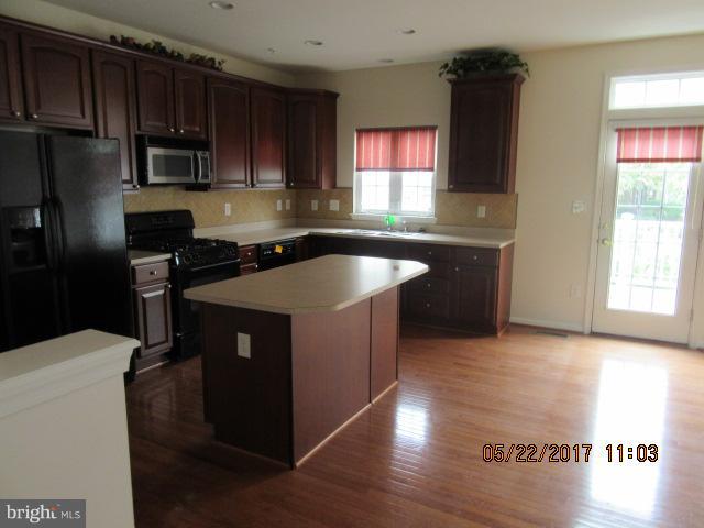 9305 Summit View Way Perry Hall, MD 21128 - Photo 2 of 12 a kitchen with stainless steel appliances granite countertop a sink stove and refrigerator