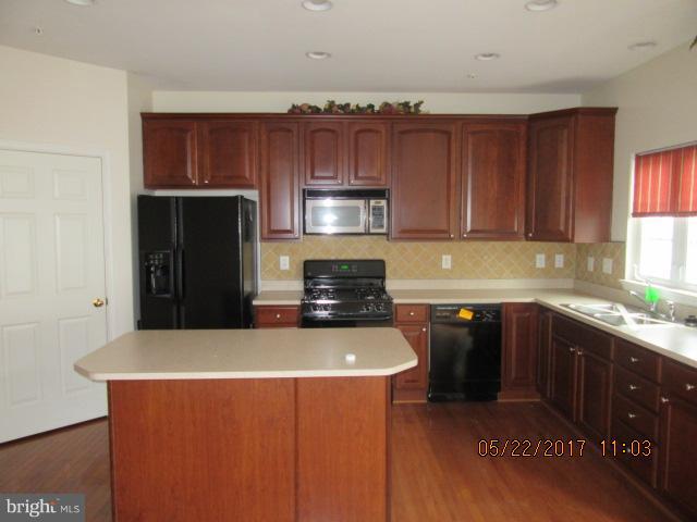 9305 Summit View Way Perry Hall, MD 21128 - Photo 3 of 12 a kitchen with granite countertop a refrigerator stove top oven with a sink and dishwasher