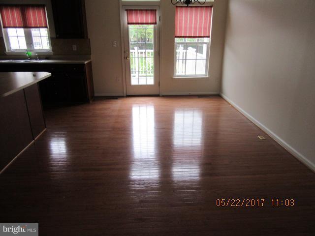 9305 Summit View Way Perry Hall, MD 21128 - Photo 4 of 12 a view of an empty room with wooden floor and a window
