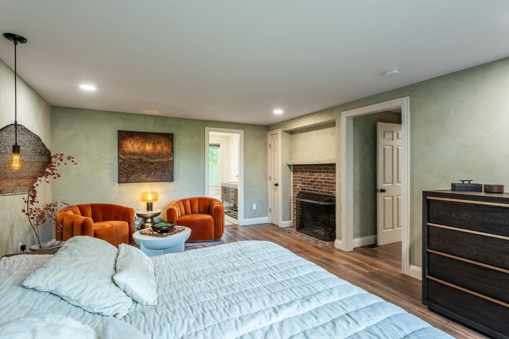 585 Station Road Amherst, MA 01002 - Photo 20 of 42 a bedroom with furniture and a fireplace