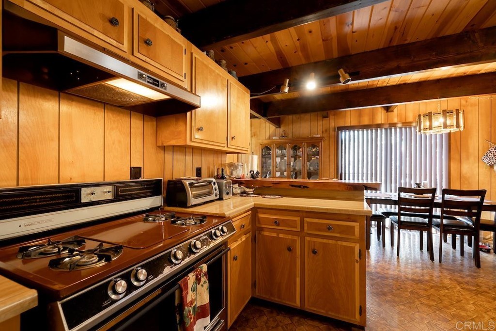 42535 Avalon Road Big Bear Lake, CA 92315 - Photo 13 of 26 a kitchen with stainless steel appliances granite countertop a stove a sink and a microwave