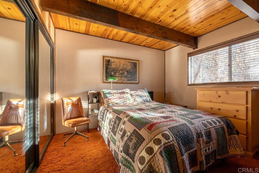42535 Avalon Road Big Bear Lake, CA 92315 - Photo 17 of 26 a bed sitting in a bedroom next to a window
