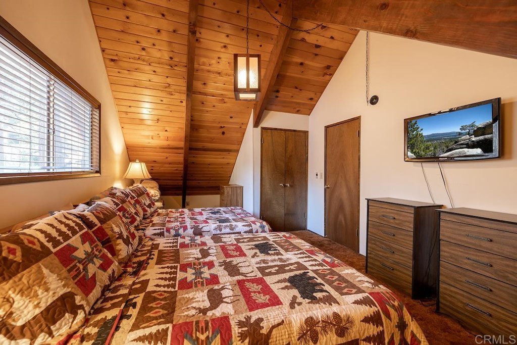 42535 Avalon Road Big Bear Lake, CA 92315 - Photo 18 of 26 a bedroom with a bed and flat screen tv
