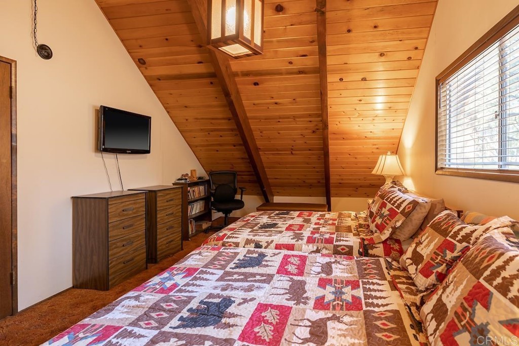 42535 Avalon Road Big Bear Lake, CA 92315 - Photo 19 of 26 a living room with a rug and a flat screen tv